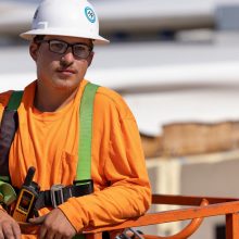 a construction worker with a white helmut staring at the camera